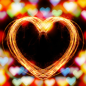Heart shaped sparkler firework alphabet with bokeh lights