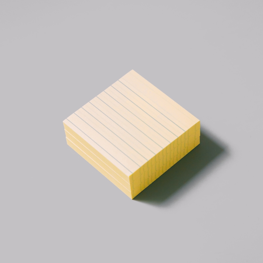 yellow lined sticky notepad on white surface